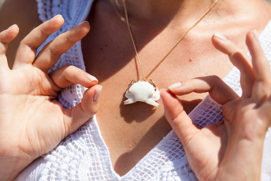 Collier crabe blanc avec pinces dorées